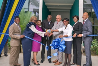 Minister of Justice, Hon Delroy Chuck (fourth right) and Chief Justice, Hon. Mr. Justice Bryan Sykes (fourth left), cut the ribbon to officially hand over the renovated St. Ann Family Court building to the Court Administration Division (CAD), on Wednesday (September 4), in St. Ann’s Bay.  Also taking part are (from left) Judge of the Court of Appeal, Justice Davis Fraser; Custos of St. Ann, Hon. Norma Walters; Permanent Secretary in the Justice Ministry, Grace Ann Stewart McFarlane; Chief Executive Officer of the CAD, Tricia Cameron Anglin; Senior Parish Court Judge, Her Hon. Mrs. Yvette Wentworth-Miller, and Chief Judge of Parish Courts, His Honour Chester Crooks.

