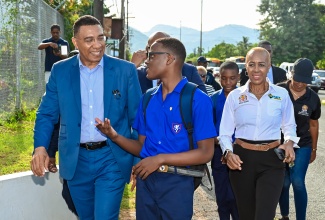 Prime Minister, the Most Hon. Andrew Holness, converses with a Jamaica College student while visiting the institution’s campus on Old Hope Road in St. Andrew, on Monday (September 2), the start of the 2024/25 academic year. Also visiting is Education and Youth Minister, Hon. Fayval Williams (right).

