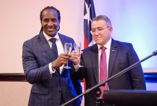 Minister of State in the Ministry of Foreign Affairs and Foreign Trade, Hon. Alando Terrelonge (left), raises a toast with the Republic of Chile’s Ambassador to Jamaica, His Excellency José Antonio Cabedo Espinosa, during Wednesday’s (September 18) reception at The Jamaica Pegasus hotel in New Kingston to mark the South American nation’s 214th Independence Anniversary.

