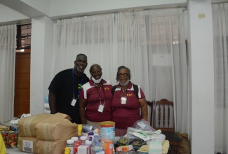 Manager of the Kingsley Thomas Medical Office in the United States (US), Dr. Leonard McLean (left), shares a photo opportunity with Senior Pastor at the Pentecostal Tabernacle Apostolic in Orlando, Florida, Fredericka Francis (centre) and missionary, Yvonne Gooden, at a free health fair held recently at the St. James Parish Church in Montego Bay.