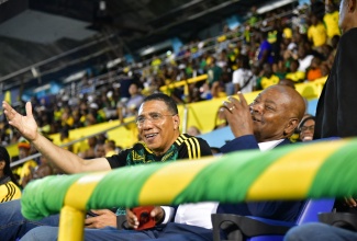 Prime Minister the Most Hon. Andrew Holness (left) and President, Jamaica Football Federation, Michael Ricketts (right) enjoy the Concacaf Nations League football match between Jamaica and Cuba at the national stadium on September 6.