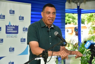 Prime Minister, Dr. the Most Hon. Andrew Holness (centre), addresses the groundbreaking ceremony for the Lancewood Pipeline Extension Project in Exchange, St. Ann, on Friday (Sept. 27).
