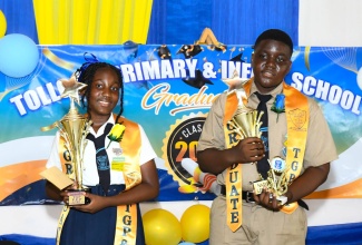 Top student at Toll Gate Primary and Infant School in Clarendon, Aalliyah Pinnock (left), and top boy, Damion Cambell, display their trophies during the recent graduation ceremony at the Assemblies of the First Born Church International, in Decoy, in the parish.

