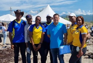 Minister without Portfolio in the Ministry of Economic Growth and Job Creation, Senator the Hon. Matthew Samuda (third right), with members of the Jamaica Information Service (JIS) team who participated in International Coastal Clean-up Day activities at the Shipwreck Beach in Kingston on Saturday, September 16, 2023. 