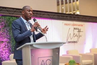 Assistant General Manager of Corporate Communications and Public Affairs at the National Housing Trust, Dwayne Berbick, speaks at a recent Build Wealth Conference at the AC Marriott Hotel in Kingston.

