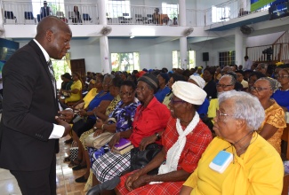 Minister of Labour and Social Security, Hon. Pearnel Charles Jr. (left), interacts with senior citizens during the National Thanksgiving Church Service to mark Senior Citizens' Month 2024, held at the Port Maria Seventh-day Adventist (SDA) Church in St. Mary on Saturday, September 14.

