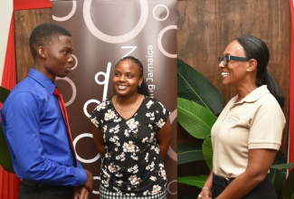 Chief Executive Officer of National Rums of Jamaica (NRJ), Martha Miller (right), engages with NRJ Foundation scholarship recipients, Demario Johnson (left) and Anuscha Hurst. The event was the Foundation’s inaugural scholarship award ceremony on Friday (Sept. 13), at NRJ, 3 Ardenne Road, St. Andrew.