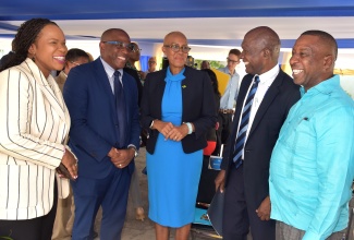 Education and Youth Minister, Hon Fayval Williams (centre), and Permanent Secretary in the Ministry, Dr. Kasan Troupe (left), interact with (from left) Overseas Examinations Commission (OEC) Chairman, Brian Bennett-Easy and Executive Director, Hector Stephenson; and Mayor of Kingston, Councillor Andrew Swaby. The event was the recent ground-breaking ceremony for the construction of the OEC’s new state of the art multipurpose facility at the entity’s Manhattan Road complex in Kingston.