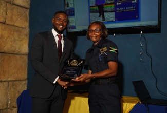 Supervisor, St. James Municipal Corporation Police Unit, Jillian Rodney, accepts the Municipal Police Officers 2024 Award from Mayor of Montego Bay and Chairman of the St James Municipal Corporation, Councillor Richard Vernon, in honour of her 20 years of dedicated service.

