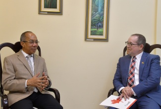 Deputy Prime Minister and Minister of National Security, Hon. Dr. Horace Chang (left), converses with Canada’s High Commissioner to Jamaica, His Excellency Mark Berman, during the Diplomat’s courtesy call at the Ministry in Kingston on Wednesday (September 18).