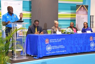 Minister of Labour and Social Security, Hon. Pearnel Charles Jr. (left), addresses the launch of Senior Citizens Month on Wednesday (September 4), at The Jamaica Pegasus hotel in New Kingston. Listening  (from left) are Chairperson, Andre Miller; Permanent Secretary in the Ministry, Collette Roberts Risden; Chief Technical Director, Audrey Deer-Williams; and National Council for Senior Citizens Board Chair, Julian McKoy Davis. 

