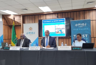 Director General, Planning Institute of Jamaica (PIOJ), Dr. Wayne Henry (centre), speaks during the agency’s June 2024 quarterly media briefing on Wednesday (September 4). Listening (from left) are PIOJ Senior Director, Economic Planning and Research, James Stewart; and Vision 2030 Jamaica Programme Director, Peisha Bryan Lee.

