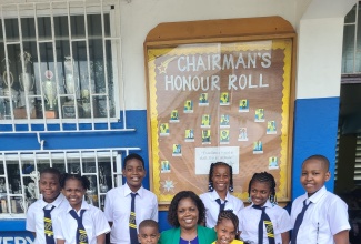 Nestled among her pupils is Principal of the Morant Bay Primary School, Fay Lindsay.

