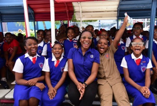 Acting Special Projects Manager at the Jamaica Information Service (JIS), Charnele Henry (seated, centre) shares a light moment with students from Lannaman’s Preparatory School (seated from left) Sabia Smellie, Tanice Barrett, Nosal Wilson, Malia DaCosta and other students, after the JIS Heritage School Tour visit to the institution on October 3. The students were engaged in an interactive discussion on the theme for Heritage Week ‘One Love, One People, One Heritage’.