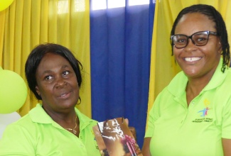 Acting Vice Principal of the St. Catherine-based Innswood High School, Camella Mullings-Wilson (right), presents a gift to member of the ancillary staff, Laurel Lawrence, at the third annual staff awards ceremony held on Tuesday (October 15) at the institution’s campus.

