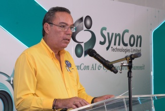 Minister of Science, Energy, Telecommunications and Transport, Hon. Daryl Vaz, delivers remarks during SynCon Technologies’ inaugural AI and Cybersecurity Summit, held at The Jamaica Pegasus hotel in New Kingston, on Thursday (October 10).  

