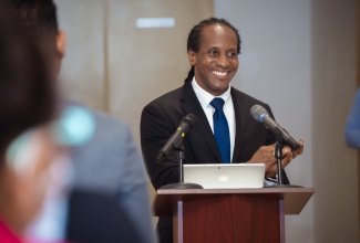 Minister of State in the Ministry of Foreign Affairs and Foreign Trade,, Hon. Alando Terrelonge, applauding customer service professionals for their invaluable contributions to the public sector, during the opening ceremony for Service Excellence Month activities at the Ministry in Kingston on October 7.

