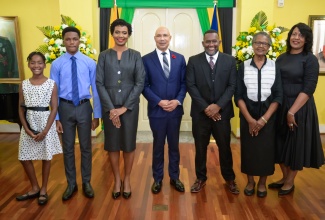 Governor-General, His Excellency the Most Hon. Sir Patrick Allen (centre), shares a photo opportunity with The Hon. Madame Justice Chantal Ononaiwu (third left), and members of her family, during Tuesday's (October 29) ceremony at King’s House, where she was sworn in as a Judge of the Caribbean Court of Justice (CCJ). Pictured (from left) are her children, Kenna and Kanu; husband, Keith; mother, Arlene; and sister, Colleen.