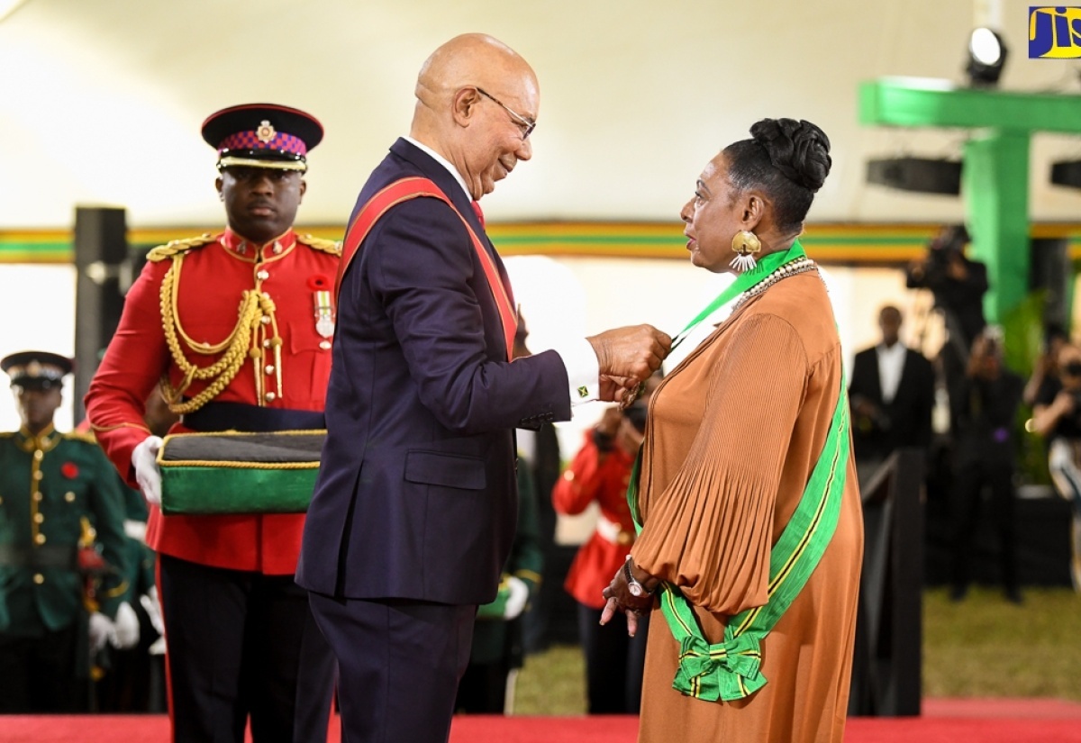 Governor-General, His Excellency The Most Hon. Sir Patrick Allen, presents Minister of Culture, Gender, Entertainment and Sport, Hon. Olivia Grange, with the Order of Jamaica (OJ), during the National Honours and Awards Ceremony held at King’s House on October 17, 2022.