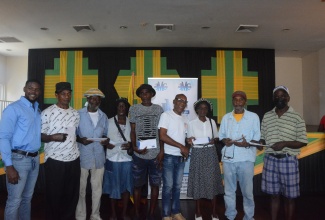 Mayor of Montego Bay, Councillor Richard Vernon (left) and the Councillor for Granville Division, Michael Troupe (fourth right) share a photo opportunity with some of the recipients of the Housing Relief Grant provided by the St. James Municipal Corporation, during the presentation ceremony on Friday (September 27), at the St. James Cultural Centre in Montego Bay.

