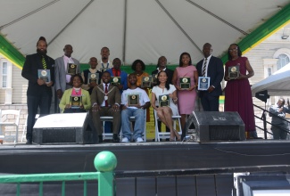 Mayor of Montego Bay, Councillor Richard Vernon (seated second left), shares a photo with the 13 awardees from St. James, during the National Heroes’ Day Civic & Awards Ceremony, held on Monday, October 21 at Sam Sharpe Square in Montego Bay.