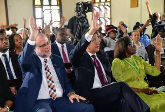 Prime Minister, Dr. the Most Hon. Andrew Holness (centre); Leader of the Opposition, Mark Golding (left); Custos Rotulorum of St. Thomas, Marcia Bennett and other congregants, raise their hands in praise during the National Heritage Week Thanksgiving Church Service at the Highholborn Street Church of God in Kingston on October  20. National Heritage Week is being celebrated under the theme: ‘One Love, One People, One Heritage’.