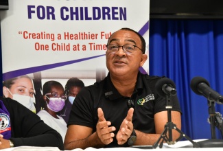 Minister of Health and Wellness, Dr. the Hon. Christopher Tufton, addresses journalists during a media briefing at the Bustamante Hospital for Children in Kingston on Thursday (October 24), to provide an update on support being extended to an 11-year-old girl ailing from scoliosis who requires surgery.