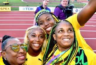 Minister of Culture, Gender, Entertainment and Sport Minister, Hon. Olivia Grange (left) and ‘Team Jamaica’ supporters, share a moment with Shelly-Ann Fraser-Pryce (second left), following her victory in the women’s 100-metre event at the 2022 World Athletics Championships in Eugene, Oregon.

