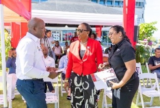 Minister of Labour and Social Security, Hon. Pearnel Charles Jr. (left), is in discussion with Chairperson of the Digicel Foundation, Joy Clarke (centre) and Chief Executive Officer of the organisation, Charmaine Daniels (right), during the recent launch of the Foundation’s 2023/2024 annual report at the organisation’s downtown Kingston offices.

