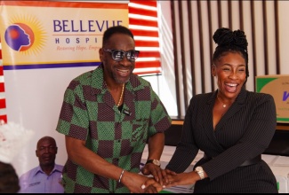Chief Executive Officer of the Bellevue Hospital, Suzette Buchanan, receives donation of two air-conditioning units, five wheelchairs and nine walkers from Rodney “Bounty Killer” Pryce on behalf of his Bounty Foundation, at the facility, on September 26