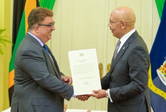 Governor General, His Excellency the Most Hon. Sir Patrick Allen (right), presents the Instrument of Office to the new Custos of St. Ann, Joseph Issa, at a recent swearing-in ceremony at King’s House in St. Andrew.

