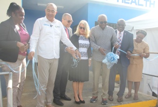 Minister of Health and Wellness, Dr. the Hon. Christopher Tufton (second left), cuts the ribbon to mark the official opening of the new $50 million Adelphi Health Centre, in St. James, on Thursday, October 17.  Also at the opening  (from left) are Medical Officer of the St. James Public Health Services, Dr. Tanique Bailey Small; Regional Director for Western Regional Health Authority, St. Andrade Sinclair; Head of the European Union Delegation to Jamaica, Belize, and The Bahamas, Dr. Erja Askola; Minister of Tourism and Member of Parliament for St. James East Central, Hon. Edmund Bartlett; Parish Manager of the St James Health Services, Lennox Wallace; and District Public Health Nurse, Lisa Benjamin-Hunter.