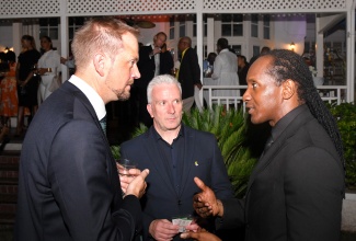 Minister of State in the Ministry of Foreign Affairs and Foreign Trade, Hon. Alando Terrelonge (right), converses with Managing Director of The Caribbean Council, Chris Bennett (left) and Deputy Managing Director at Yanco Limited, Kevin Riozzi. Occasion was a welcome reception for the United Kingdom (UK) Trade Mission to Jamaica at the UK High Commissioner’s residence in Kingston on Tuesday (October 1).