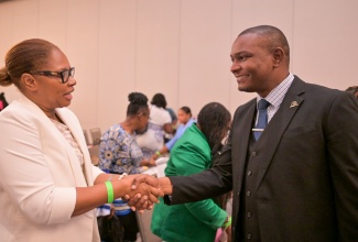 President of the Jamaica Teachers’ Association (JTA), Mark Smith and Chief Education Officer, Special Education Unit, Ministry of Education and Youth, Dionne Gayle, exchange a warm handshake. Occasion was the Mico University College Child Assessment and Research in Education (CARE) Centre’s 8th Biennial Education Conference on October 18 at the AC Marriott Hotel in Kingston.