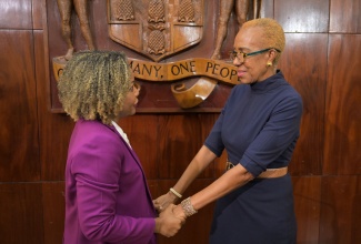 Newly appointed Minister of Finance and the Public Service, Hon. Fayval Williams (right), shares a moment with new Minister of Education, Skills, Youth and Information, Senator Dr. Dana Morris Dixon during Wednesday`s (October 30) post-Cabinet press briefing at Jamaica House. 