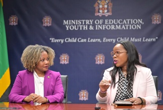 Minister of Education, Skills, Youth and Information, Senator Dr. the Hon. Dana Morris Dixon (left), converses with Permanent Secretary, Dr. Kasan Troupe, following a tour of the Ministry's head office in Kingston on Wednesday (October 30).

