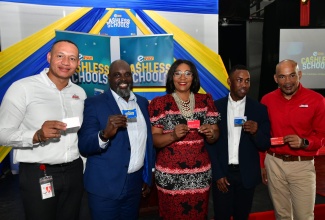 Technical Support Officer in the Office of the Permanent Secretary, Ministry of Education and Youth, Dr. Nahema Daniels-Heath (centre), displays the cashless schools ePay card during the launch at Campion College in St. Andrew on Tuesday (October 29). Others (from left) are Country Corporate Client Partnership Officer, Jamaica Money Market Brokers (JMMB) Bank, Alwayne Cousins; Chief Executive Officer of ePay Jamaica, Havanah Llewellyn; Chairman, Norbrook Transaction Services, Khary Robinson; and Chief Executive Officer, JMMB Bank Jamaica and Group Banking Lead, Jerome Smalling.

