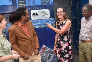 British High Commissioner to Jamaica, Her Excellency Judith Slater, points to the UK-JA Mural, which was unveiled this morning (October 16) in the Kingston Creative Art District. Looking on (from left) are United Kingdom (UK) Minister for Latin America and the Caribbean, Baroness Jennifer Chapman; Artist, Michael Elliott; and Permanent Secretary in the Ministry of Culture, Gender, Entertainment and Sport, Denzil Thorpe. The mural, titled ‘Tale of Two Cities’ showcases the vibrant collaboration between art and diplomacy and celebrates the cultural ties and creativity of both countries.

