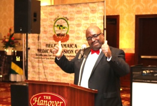 President of Help Jamaica Medical Mission (HelpJaMM), Dr. Robert Clarke, gives the thumbs up as he provides an overview of the organisation’s work this year. Occasion was HelpJaMM’s 14th annual black-tie gala held recently at the Hanover Manor, New Jersey. 