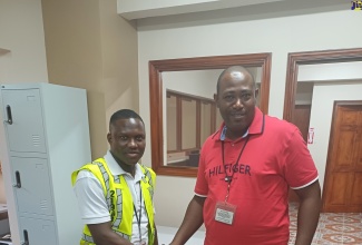 Constables Roger Douglas (left) and Denene Benjamin stop by the Jamaica Information Service’s (JIS) St. Thomas Regional Office to discuss their radio programme, ‘Let’s Get it Right’.