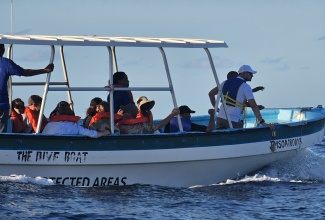 His Royal Highness, Crown Prince Haakon of Norway (right), is given a boat tour of the Oracabessa Bay Fish Sanctuary in St. Mary on Tuesday (November 19).

