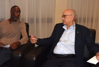 Chairman of Independence Park Limited, Mike Fennell, converses with former 200m and 400m world record holder, Michael Johnson, during the media launch of the Grand Slam Track Kingston Meet at the Jamaica Pegasus Hotel in New Kingston on Monday (November 11). 