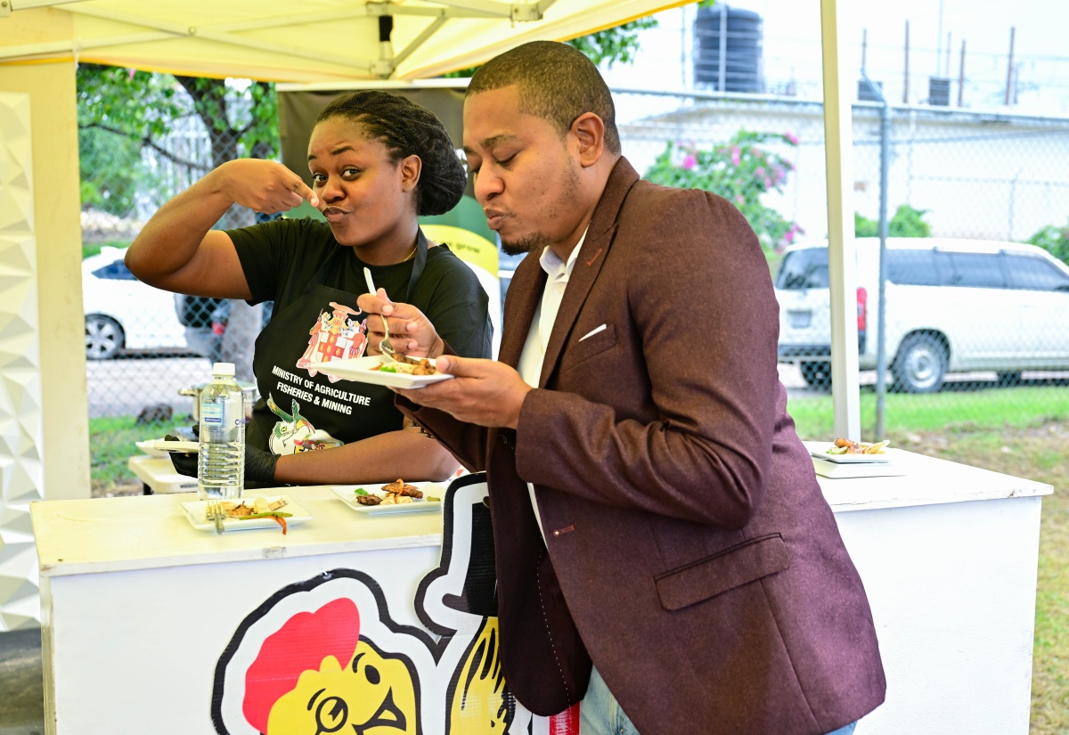 Minister of Agriculture, Fisheries and Mining, Hon. Floyd Green (right) samples a dish prepared by Kibbieshe Kennedy, a contestant in the Ministry’s Eat Jamaican Month Cook Off competition, held on Friday (November 29) at the Ministry’s Hope Complex in Kingston.