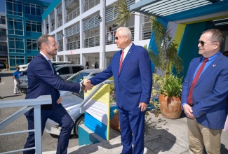 Minister of Justice, Hon. Delroy Chuck (centre), greets United Nations Development Programme (UNDP) Goodwill Ambassador, His Royal Highness, Crown Prince Haakon of Norway, during his tour of a Mobile Justice Unit at the Ministry’s Head Office in Kingston on Tuesday (November 19). At right is Canada’s High Commissioner to Jamaica, His Excellency Mark Berman.

