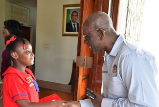 Minister of Local Government and Community Development, Hon. Desmond McKenzie, greets Portmore Youth Mayor, Tanice Webster, during a recent courtesy call by Youth Mayors at the Office of the Prime Minister in Kingston. The visit was part of activities for Local Government and Community Month during November.

