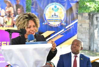 Minister of Education, Skills, Youth and Information, Senator Dr. the Hon. Dana Morris-Dixon,  addresses a career and social services fair hosted by Minister of Labour and Social Security and Member of Parliament for Clarendon South Eastern, Hon. Pearnel Charles Jr. (right), at Palmers Cross Primary & Junior High School in the parish on Wednesday (Nov. 20).