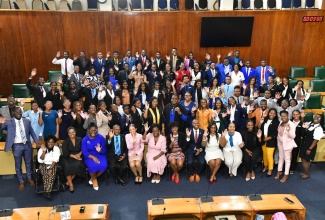 Clerk of the Houses of Parliament, Colleen Lowe (seated fifth right); Director, Corporate Communications and Public Relations, Houses of Parliament, Tashana Sewell (seated sixth left); other parliamentary staff members and stakeholders share a photo opportunity with members of the national youth parliament of Jamaica following its sitting at Gordon House on Nov 25.