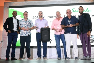 Vice President of Trade Sales for Unique Vacations, United States, Garth Laird (left), and Director of Operations at Sandals Golf Upton Estate Country Club, Jonathan Newnham (right), join winners of Sandals’ 20th USA Travel Advisor Golf Tournament, at the awards ceremony held at Sandals Ochi in St. Ann on October 28. The winning team members are (from left) Adam Anderson, David Anderson, David Schutz and Jeremy Lee.

