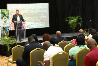 Minister of State in the Office of the Prime Minister (West), Hon. Homer Davis, addresses the recent World Town Planning Day (WTPD) forum at the Montego Bay Convention Centre in Rose Hall, St. James.

