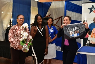 Minister of Foreign Affairs and Foreign Trade, Senator the Hon. Kamina Johnson Smith (right), shows off the Immaculate Conception High School (ICHS)-branded gift she received after addressing students at a college fair held on the school grounds in St. Andrew on Thursday (Oct. 31). Sharing the moment (from left) are Upper School vice principal, Andrea Hitchener; Grade Coordinator, Kadesha Croney; and student,  Rihanna Persaud.